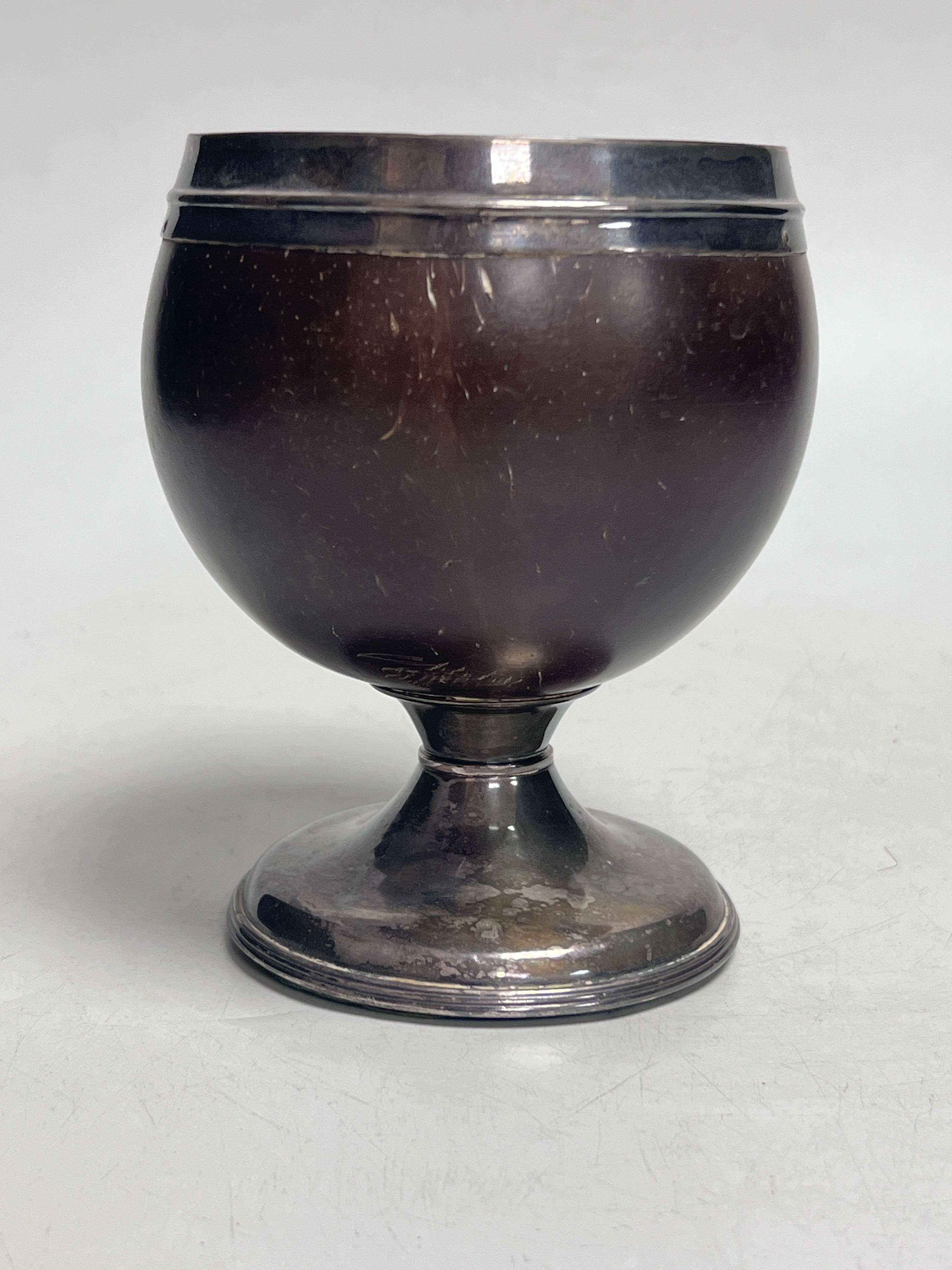 An early 19th century white metal mounted coconut cup, 13cm high